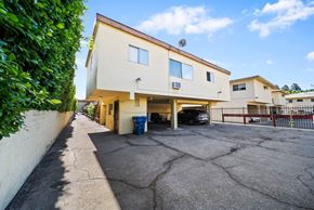 Glendale apartment for rent - A two-story building with a parking lot in front.