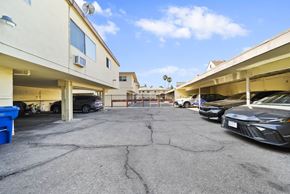 Glendale apartment for rent - A parking lot with cars and a building in the background.