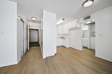 Los Angeles apartment for rent - A kitchen with white cabinets and a wooden floor.