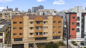 Los Angeles apartment for rent - A view of a cityscape with a large building in the foreground.