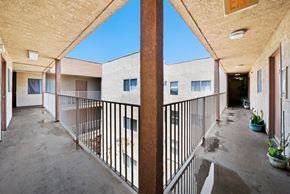 Los Angeles apartment for rent - A balcony with a metal railing and potted plants.