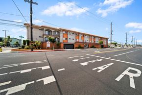 Hawthorne apartment for rent - A street with a building and a sign that says "STOP".