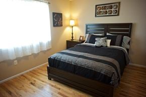 Staten Island apartment for rent - A bedroom with a bed, nightstand, and lamp. at Seaview Apartments in Staten Island, NY, 10305
