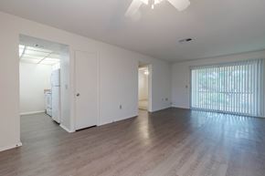 Clearwater apartment for rent - A spacious room with a ceiling fan and wooden flooring at Imperial Gardens Apartments, Clearwater 33764