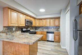 Staten Island apartment for rent - A kitchen with wooden cabinets and a granite countertop at Seaview Apartments in Staten Island, NY, 10305