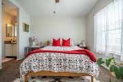 El Paso apartment for rent - A bedroom with a large bed and a red pillow.