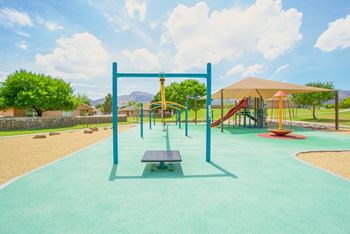 A playground with a swing set and a picnic table