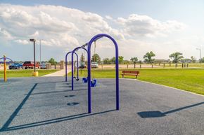 Box Elder apartment for rent - A blue swing set and parking lot.