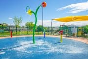 El Paso apartment for rent - a water park with a yellow and red water slide at Village of Cottonwood Springs in El Paso, TX