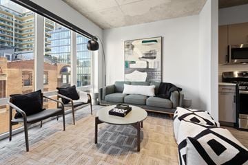 Chicago apartment for rent - A modern living room with a grey couch and a coffee table.