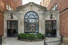 Chicago apartment for rent - the facade of a building with a large window and a courtyard