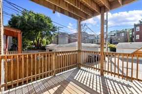 Chicago apartment for rent - A wooden deck with a roof and a view of the street.