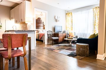 Chicago apartment for rent - A living room with a red chair in the foreground.