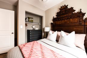 Chicago apartment for rent - A bedroom with a large bed and a wooden headboard.