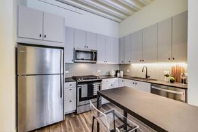 Chicago apartment for rent - a kitchen with white cabinets and stainless steel appliances