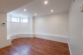 Chicago apartment for rent - A room with wooden floors and white walls.