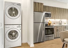 Chicago apartment for rent - a kitchen with a washing machine and a stainless steel refrigerator