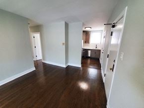 Chicago apartment for rent - an empty living room and kitchen with wood floors