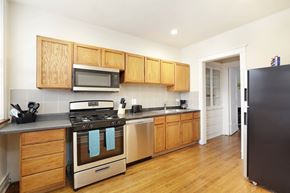 Chicago apartment for rent - a kitchen with stainless steel appliances and wooden cabinets