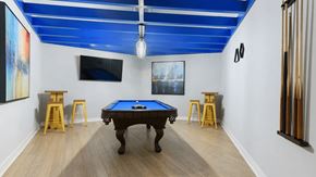Algonquin apartment for rent - A pool table is in the middle of a room with a blue ceiling.