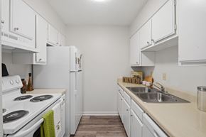 Lafayette apartment for rent - A kitchen with white cabinets and a white stove.