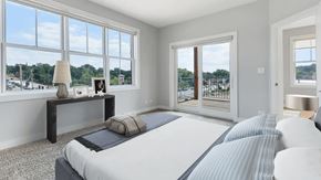 Algonquin apartment for rent - A bedroom with a large bed and a view of the outside through the windows.