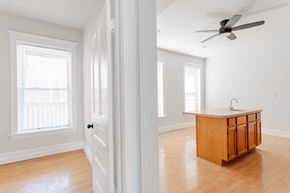 Chicago apartment for rent - A room with a wooden cabinet and a ceiling fan.