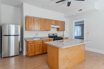 Chicago apartment for rent - A kitchen with wooden cabinets and a marble countertop.