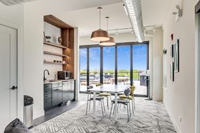 Chicago apartment for rent - a dining area with a white table and chairs and a large window with a view of a