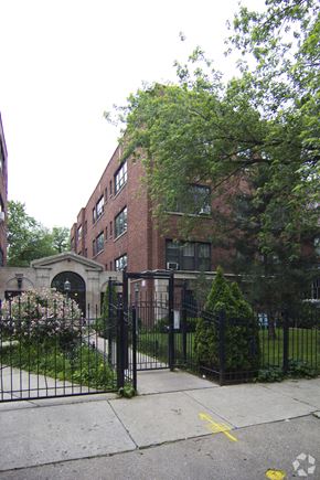 Chicago apartment for rent - a building with a fence and a gate in front of it