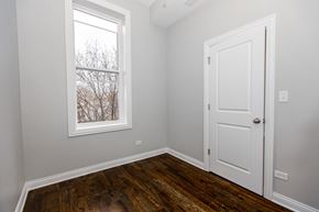 Chicago apartment for rent - a bedroom with wood floors and a window