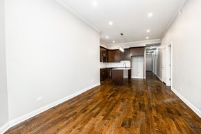 Chicago apartment for rent - a living room and kitchen with wood floors and white walls