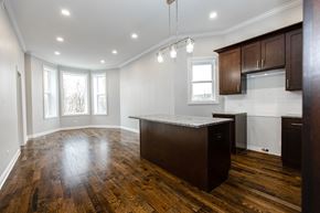 Chicago apartment for rent - an empty kitchen with a large island in the middle