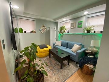 Chicago apartment for rent - A living room with a yellow bean bag chair and a blue couch.