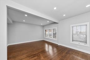 Chicago apartment for rent - A room with wooden floors and white walls.