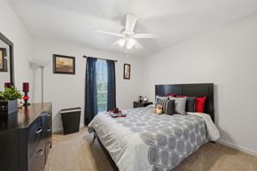 Lafayette apartment for rent - A bedroom with a large bed and a ceiling fan.