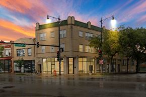 Chicago apartment for rent - a building on the corner of a street at sunset