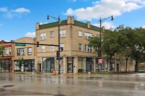 Chicago apartment for rent - a large building on the corner of a street with traffic lights