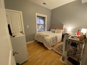 Chicago apartment for rent - a bedroom with a bed and a desk and a window
