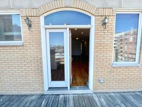 Chicago apartment for rent - the entrance to a brick building with an open door