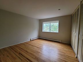 Chicago apartment for rent - the living room of a house with wooden floors and a window