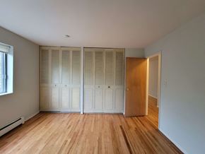 Chicago apartment for rent - a bedroom with two closets and a wood floor