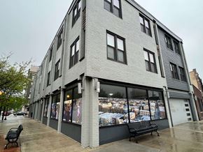 Chicago apartment for rent - a building with a large window with a bench in front of it