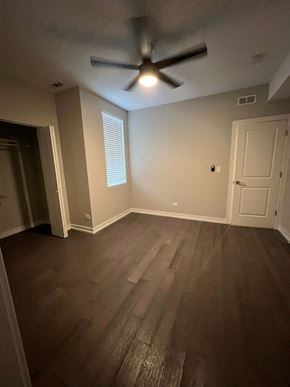 Chicago apartment for rent - an empty living room with a ceiling fan and hardwood floors