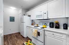 Clermont apartment for rent - A kitchen with white cabinets and appliances.