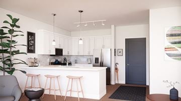 Naperville apartment for rent - A modern kitchen with white cabinets and a bar area.