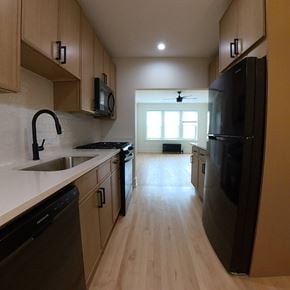 Chicago apartment for rent - A kitchen with black appliances and wooden cabinets.