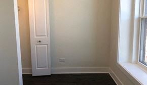 Chicago apartment for rent - A white door is in a room with a window.