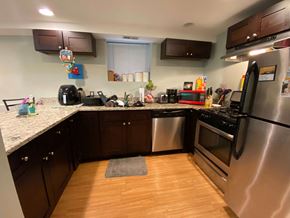 Chicago apartment for rent - A kitchen with wooden floors and stainless steel appliances.