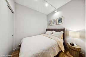 Chicago apartment for rent - a bedroom with a bed and a night stand